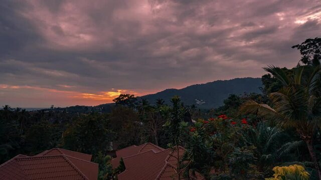 Panorama Of Colorful Dramatic Sunset Over Forest Valley, Tropical Green, Rooftops, Mountains And Sea. 4k Time-lapse