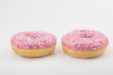Two pink donuts on a white background
