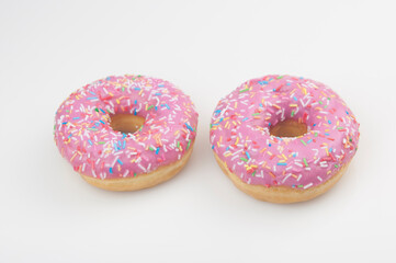 Two pink donuts on a white background