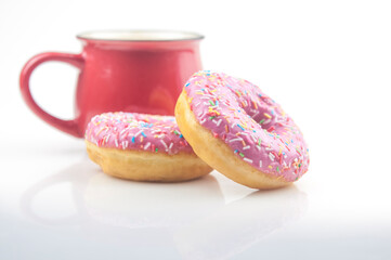 Tasty donut with a cup of coffee on white background