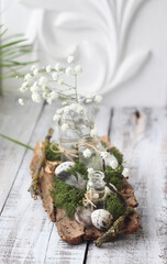 Spring decor with eggs, flowers and moss