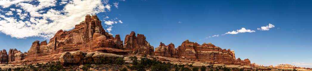 Fototapeta premium Panorama shot of mesas and buttes in canyonlands national park at sunny day in Utah, America