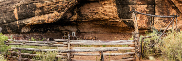 Wide shot of historic cowboy cave spring with old furniture in canyonlands national park in Utah, america