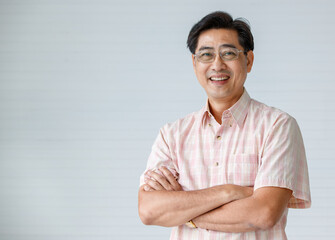 Portrait of warm personality senior older man wearing eyeglasses with smile face folding crossed...
