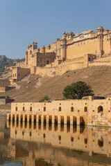 View and reflection of Amber Fort and Palace build by Rajput King Sawai Mansingh in 1592, Jaipur, Rajasthan, India.