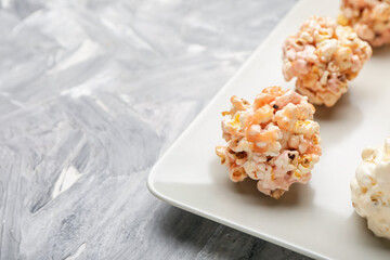 Tray with tasty popcorn balls on grey background