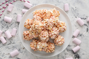 Fototapeta na wymiar Dessert stand with tasty popcorn balls on grunge background
