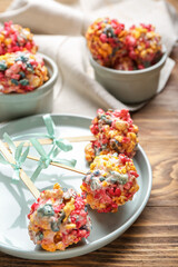 Composition with tasty popcorn balls on wooden background