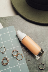 Bottle of makeup foundation and accessories, closeup