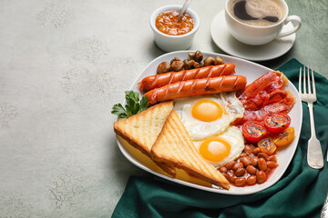 Traditional English breakfast with fried eggs in plate on light background