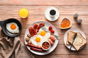 Traditional English breakfast with fried eggs on wooden background