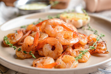 Plate with tasty shrimps on table, closeup