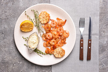 Plate with tasty shrimps and sauce on grey background