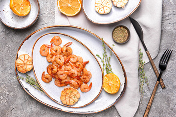 Plate with tasty shrimps on grey background