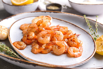Plate with tasty shrimps on table, closeup