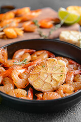 Frying pan with tasty shrimps on table, closeup
