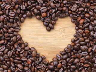 Heart shape made from coffee beans on wooden background, Coffee beans in heart shape, heart shaped roasted coffee beans