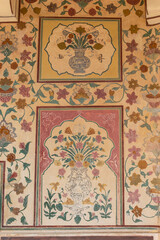 Decorative design and floral paintings on wall of Amber Palace, Jaipur, Rajasthan, India.