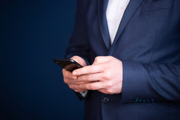 Close up of a businessman using mobile smart phone