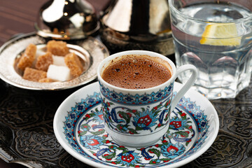 Cup of coffee in oriental style on metal tray
