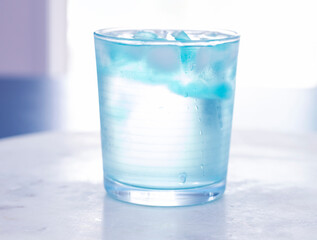 glass of water on blurred light background