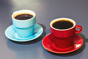 two cups of cofee on grey board