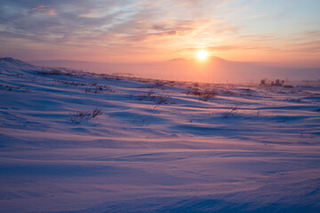 Winter arctic landscape. Satellite dishes in the winter snow-covered tundra in the Arctic. Sunset...