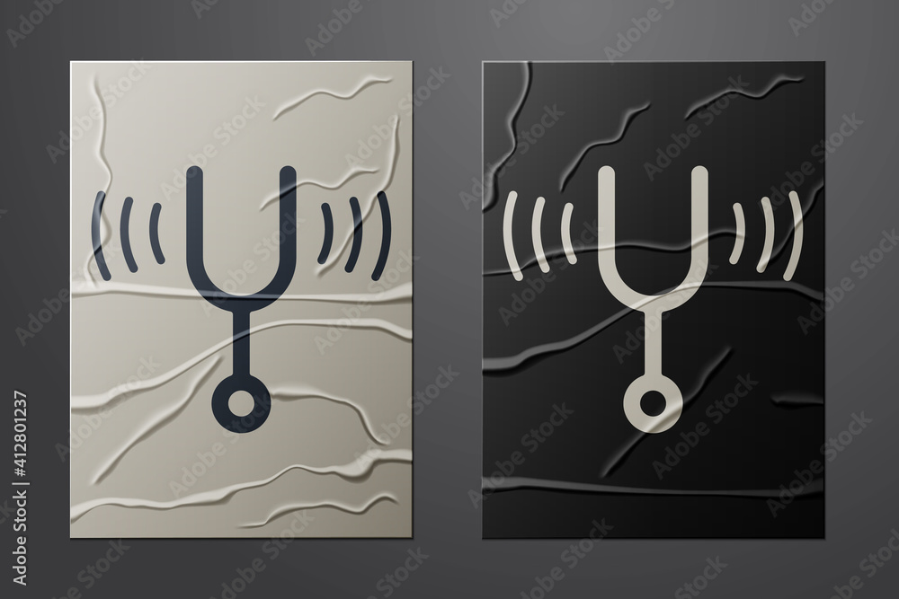 Poster white musical tuning fork for tuning musical instruments icon isolated on crumpled paper background.