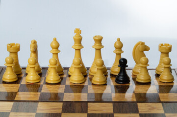 A foreing pawn in a chess set on a chess board
