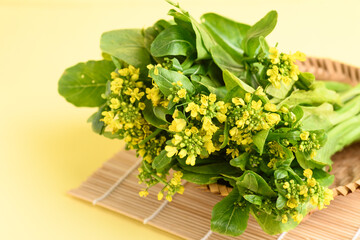 Fresh bunch organic mustard green with flowers in a basket