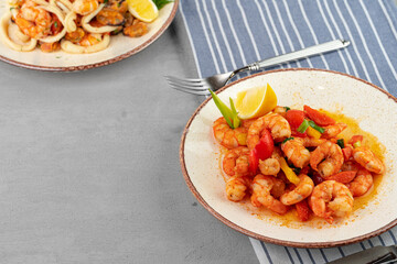 Stir fried seafood with sauce on plate with napkin
