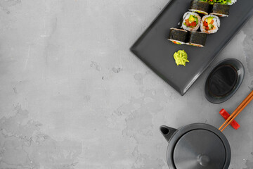 Vegeterian sushi roll with vegetables on gray background