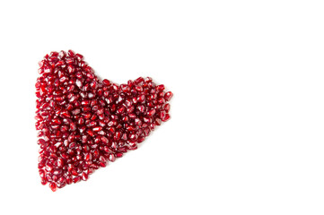 Obraz na płótnie Canvas Heart from pomegranate seeds on a white background.