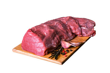 Fresh raw veal tenderloin meat in a large piece on a wooden cutting board is isolated on a white background.