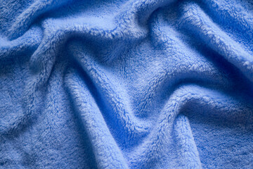Fototapeta na wymiar Luxuriors blue towel fabric or silk abstract background. of texture and pattern of colorful blue mess towel fur fabric, top view or flat lay with space for your text.