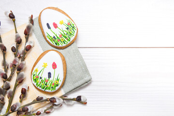 Easter gingerbread set and willow twig on white wooden background.  Easter  eggs  gingerbread