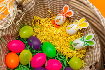 Fototapeta na wymiar Basket Colorful Easter eggs bunny ears. Funny Easter concept.Close-up.