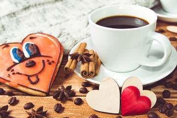 Valentine's day concept . Cup of coffee and two heart on wooden background with food decor.