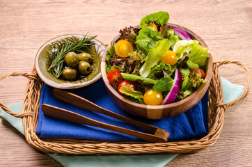 Healthy organic fresh vegetable salad, fresh leaves mix salad in wooden bowl on wooden table Healthy and Diet food.