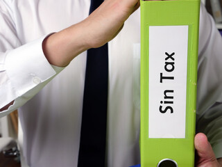  Sin Tax inscription on the piece of paper.