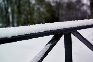 Abstract photo of iron struts covered with soft fresh snow