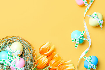Easter frame. Colorful egg with tape ribbon, spring tulips, feathers on pastel yellow background in Happy Easter decoration. Festive design in flat lay.