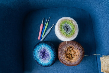 Balls of colored yarn for hand knitting on dlue background. Top view