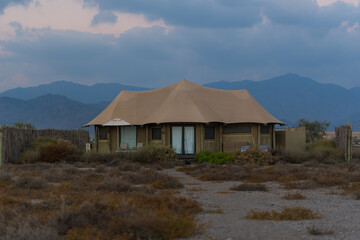 Brown tent  with beautiful moutain landscape on the background. Eco tourism concept. 