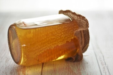 honey with honeycomb in a glass jar