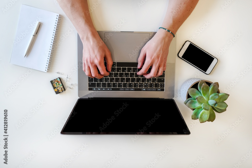 Poster a male programmer works in front of a laptop screen in a bright office or remotely from home. workpl