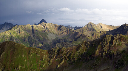 A panoramic shot of a valley under the sky. The realistic scenery of the shot reflects the valley's aesthetic.