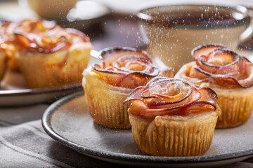  Rose apple puffs and falling icing sugar, close-up view