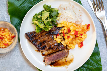 Seared tuna steak with pineapple salsa, rice and avocado