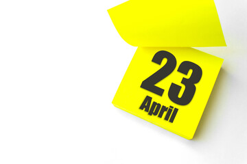 April 23rd. Day 23 of month, Calendar date. Close-Up Blank Yellow paper reminder sticky note on...